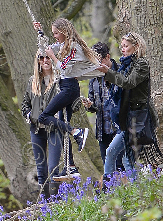 Kate Moss pushes daughter Lila Grace on rope swing  while friend look on