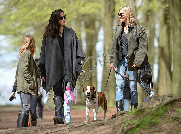 Supermodel Kate Moss wearing military style jacket, skinny jeans and cowboy boots takes a walk with her dog Archie and Liv Tyler who looked cool wearing a poncho teamed with Hunter wellies