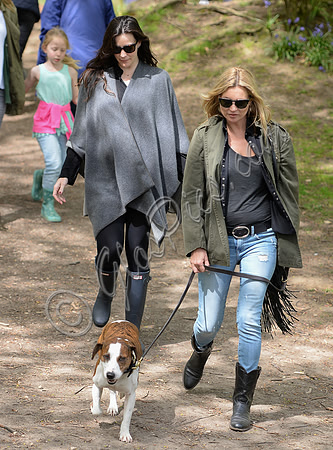 Supermodel Kate Moss wearing military style jacket, skinny jeans and cowboy boots takes a walk with her dog Archie and Liv Tyler who looked cool wearing a poncho teamed with Hunter wellies