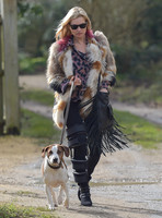 Kate Moss wearing Isabel Marant fur jacket and suede ankle boots with her dog Archie