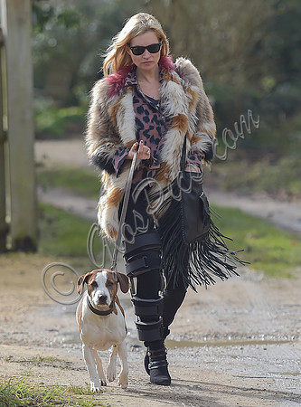 Kate Moss wearing Isabel Marant fur jacket and suede ankle boots with her dog Archie
