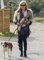 Kate Moss wearing Isabel Marant fur jacket and suede ankle boots with her dog Archie