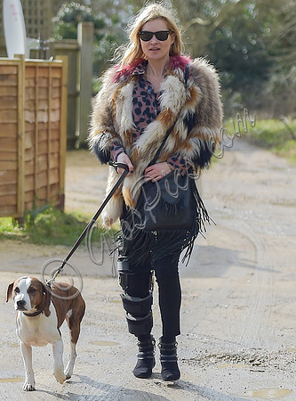 Kate Moss wearing Isabel Marant fur jacket and suede ankle boots with her dog Archie