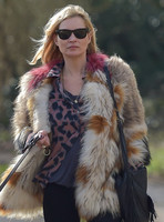Kate Moss wearing Isabel Marant fur jacket and suede ankle boots with her dog Archie