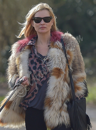 Kate Moss wearing Isabel Marant fur jacket and suede ankle boots with her dog Archie