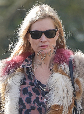 Kate Moss wearing Isabel Marant fur jacket and suede ankle boots with her dog Archie