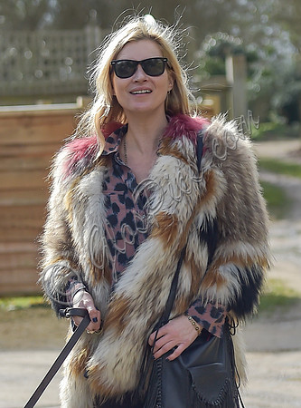 Kate Moss wearing Isabel Marant fur jacket and suede ankle boots with her dog Archie