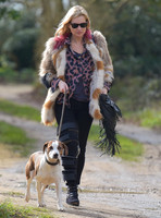 Kate Moss wearing Isabel Marant fur jacket and suede ankle boots with her dog Archie