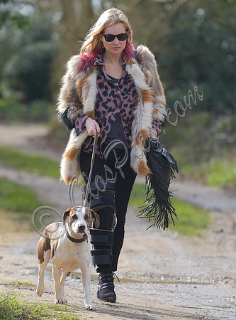 Kate Moss wearing Isabel Marant fur jacket and suede ankle boots with her dog Archie