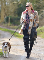 Kate Moss wearing Isabel Marant fur jacket and suede ankle boots with her dog Archie