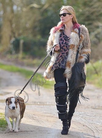 Kate Moss wearing Isabel Marant fur jacket and suede ankle boots with her dog Archie