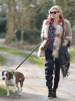 Kate Moss wearing Isabel Marant fur jacket and suede ankle boots with her dog Archie