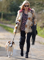 Kate Moss wearing Isabel Marant fur jacket and suede ankle boots with her dog Archie
