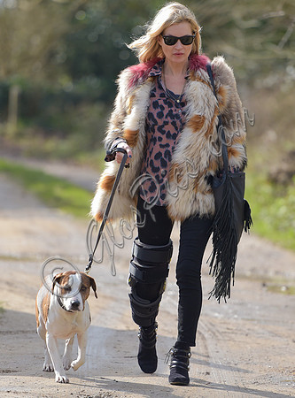 Kate Moss wearing Isabel Marant fur jacket and suede ankle boots with her dog Archie