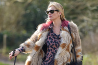 Kate Moss wearing Isabel Marant fur jacket and suede ankle boots with her dog Archie