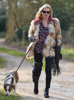 Kate Moss wearing Isabel Marant fur jacket and suede ankle boots with her dog Archie