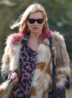 Kate Moss wearing Isabel Marant fur jacket and suede ankle boots with her dog Archie