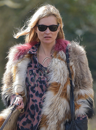 Kate Moss wearing Isabel Marant fur jacket and suede ankle boots with her dog Archie