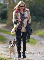 Kate Moss wearing Isabel Marant fur jacket and suede ankle boots with her dog Archie