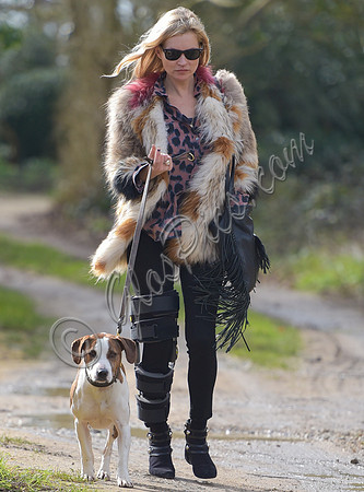 Kate Moss wearing Isabel Marant fur jacket and suede ankle boots with her dog Archie