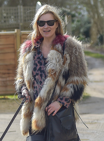 Kate Moss wearing Isabel Marant fur jacket and suede ankle boots with her dog Archie