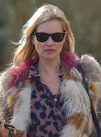 Kate Moss wearing Isabel Marant fur jacket and suede ankle boots with her dog Archie