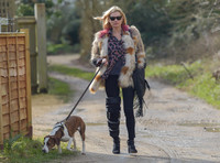 Kate Moss wearing Isabel Marant fur jacket and suede ankle boots with her dog Archie