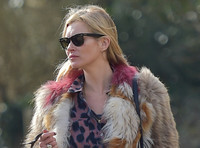 Kate Moss wearing Isabel Marant fur jacket and suede ankle boots with her dog Archie