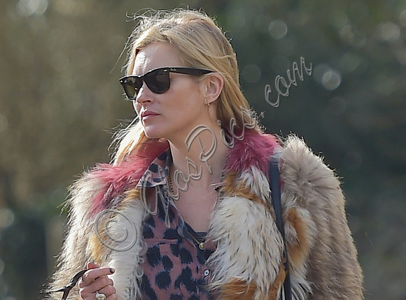 Kate Moss wearing Isabel Marant fur jacket and suede ankle boots with her dog Archie