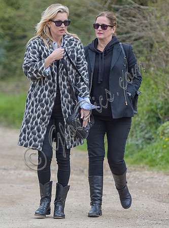 Kate Moss wearing Gucci mohair animal print overcoat with one other female