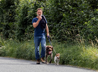 Andrew Lincoln dressed casually walking his two dogs