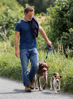 Andrew Lincoln dressed casually walking his two dogs