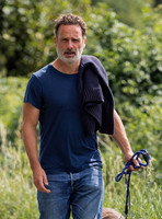 Andrew Lincoln dressed casually walking his two dogs