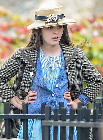 close up of Georgia Brinkworth as Phyll with hand on hips wearing straw hat