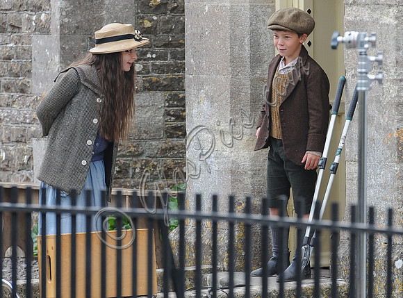Young Loll and Phyll in the school yard behind railings