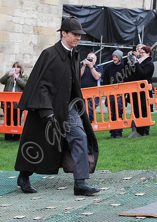 Benedict Cumberbatch as Sherlock, wearing Inverness cape and deerstalker