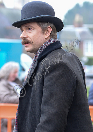 Head shot side view of Martin Freeman wearing Derby hat