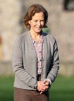 Jenny Seagrove in handcuffs wearing calf length skirt and thick woolly stockings