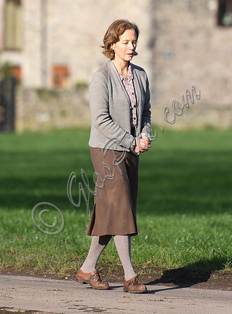 Jenny Seagrove in handcuffs wearing calf length skirt and thick woolly stockings