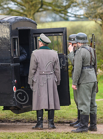 Nazi soldiers at the rear of a Black Maria