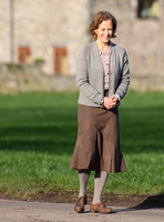 Jenny Seagrove in handcuffs wearing calf length skirt and thick woolly stockings