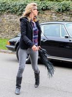 wearing trademark grey skinny jeans, black boots and a pair of Ray-Ban Wayfarer sunglasses, striped 'T', plaid shirt, hoodie with tailored jacket,  carrying Genevieve Jones fringed bag