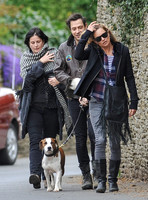 full length walking  towards camera, Jamie Hince with Archie on lead, Kate Moss and friend alongside.