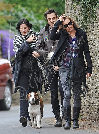 full length walking  towards camera, Jamie Hince with Archie on lead, Kate Moss and friend alongside.