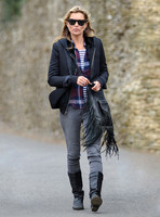full-lenghth, Kate Moss wearing grey skinny jeans, black boots, Ray-Ban Wayfarer sunglasses, striped 'T', plaid shirt, hoodie with tailored jacket, carrying Genevieve Jones fringed bag