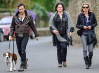 full length walking  towards camera, Jamie Hince with Archie on lead, Kate Moss and friend alongside.