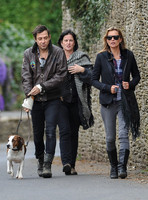 full length walking  towards camera, Jamie Hince with Archie on lead, Kate Moss and friend alongside.