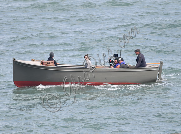 Lily James filming scenes from "Guernsey" at Clovelly Harbour