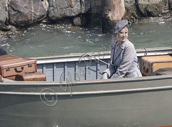 Lily James filming scenes from "Guernsey" at Clovelly Harbour