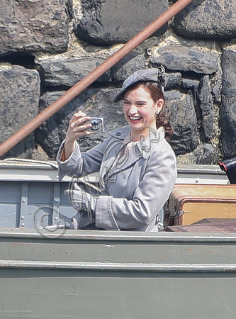 Lily James filming scenes from "Guernsey" at Clovelly Harbour